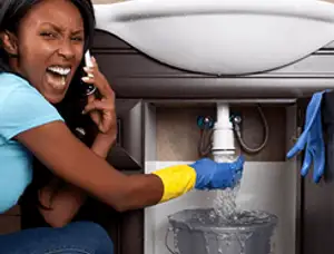 Emergency plumbing repair for a leaking sink drain under a bathroom vanity in Colorado Springs, CO