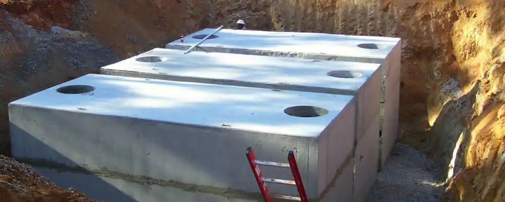 Septic tank installation site with a newly placed concrete tank in Colorado Springs, CO